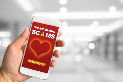 Phone showing warning against online dating scams